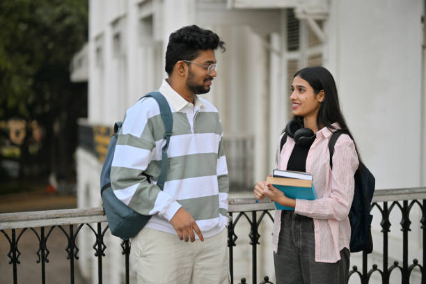 istock University students standing and discussing on the campus 2189740614