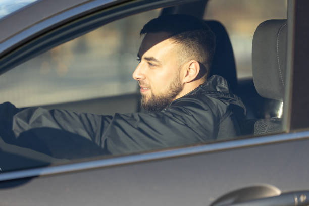 istock A handsome man sits focused behind the wheel, driving a car 2189744028