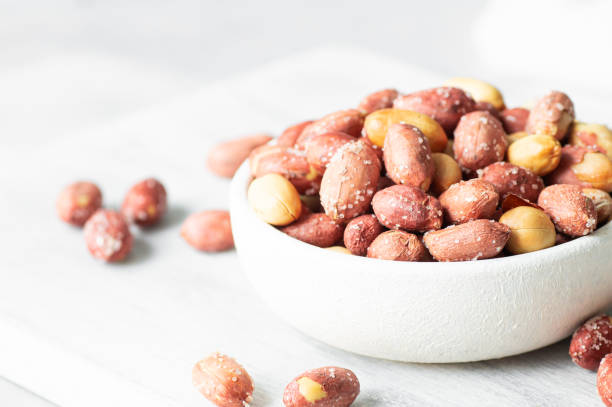 istock Roasted salty peanut without Shell in bowl or burlap sack on rustic background, concept of nuts 2189745067