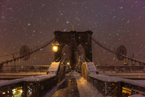 istock Brooklyn bridge in covered in snow during the sunrise 2189746351