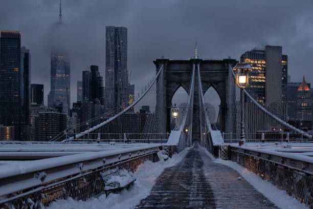 istock Brooklyn Bridge covered in snow, with the view on Manhattan financial district during the dawn, sunrise 2189746465