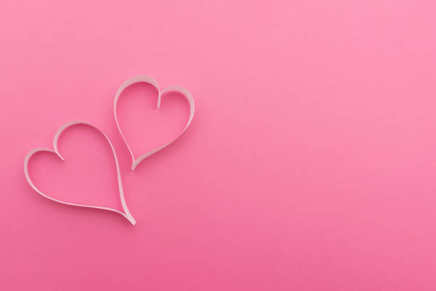 istock Two paper hearts creating romantic atmosphere for valentine's day on pink background 2189748310