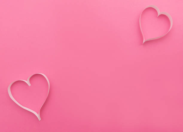 istock Two white paper hearts creating romantic atmosphere on pink for valentine's day 2189748311