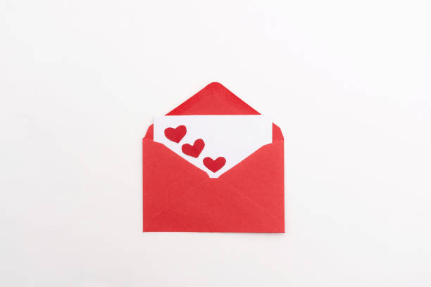 istock Red envelope with blank card decorated with three hearts on white background, a valentine's day invitation or love letter 2189748335