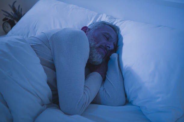istock Elderly man peacefully sleeping in bed wearing comfortable pajamas during early morning 2189748516