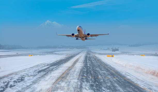 istock Commercical white airplane fly up over take-off runway the (ice) snow-covered airport- Norway 2189748636