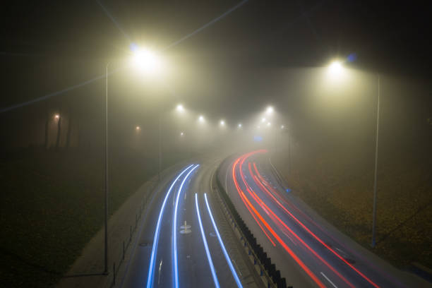 istock Fog over the night road 2189748980