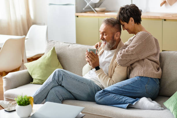 istock Loving couple enjoys cozy moment together at home while sharing a warm beverage 2189749639