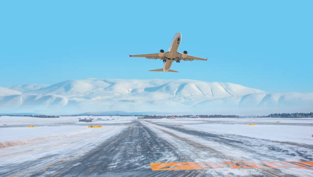 istock Commercical white airplane fly up over take-off runway the (ice) snow-covered airport- Norway 2189750058