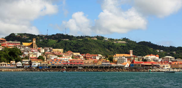 panoramic view of St George in Grenada which is the capital, and is located on the shoreline with lots of small shacks and buildings