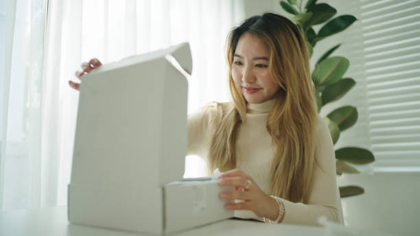 istock Woman unpacking from online shopping. 2189750326