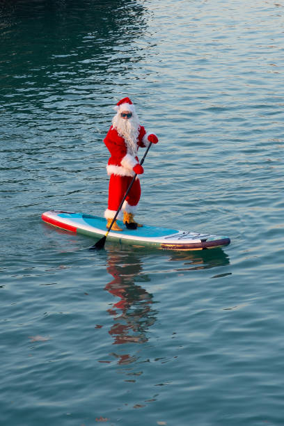 istock Santa in sunglasses stand on paddle board. Christmas, New Year 2189751228