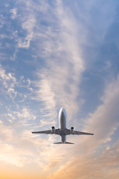 istock Airplane flying over tropical sea at sunset 2189752834