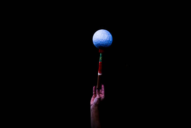 put the ball on the wooden stick