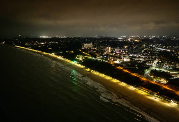 istock Bournemouth East Cliff coastline at night 2189753317