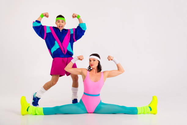 istock Energetic young couple in vibrant retro activewear demonstrating dynamic workout poses perfect for a fun fitness routine 2189754745