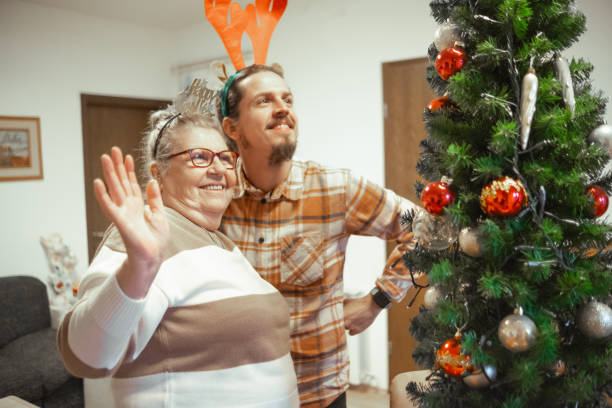 istock Cheerful multi-generational family decorating Christmas tree 2189755298