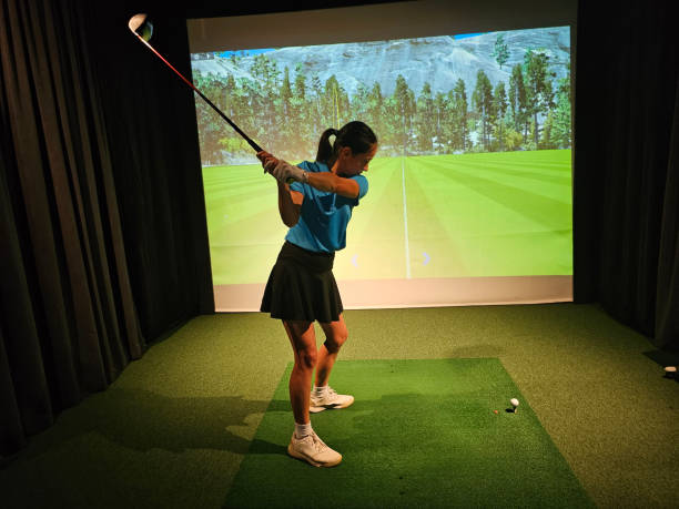 istock Young golfer practices swing in indoor simulation at a training facility concept 2189756462