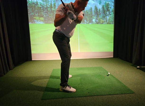 istock Indoor golf practice session with a player swinging on a simulated course concept 2189756463