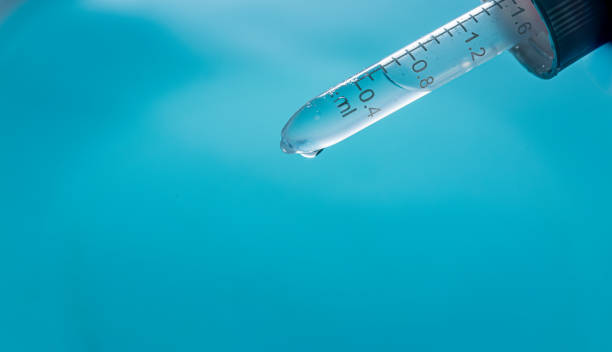 istock Close-up science experiments,Close up view macro shot of gel with different sized bubbles comes out from lab dropper into petri dish on blue background , Abstract face care gel with 2189757416