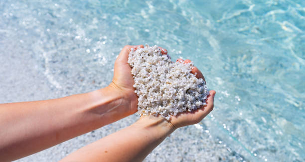 istock Woman holding heart shaped white sand at is auras beach 2189758245