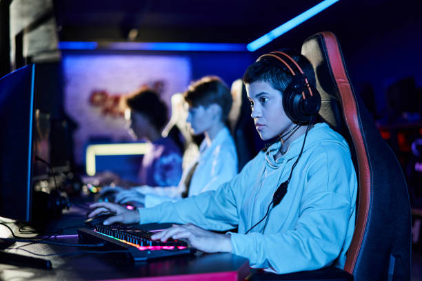 istock Young female friends enjoying gaming at an Internet cafe during a weekend outing 2189761522