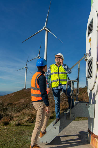 istock Engineers inspecting a wind turbine for green energy production 2189762686