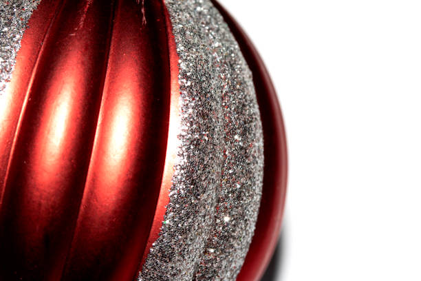 Close-up of shimmering pink and purple Christmas baubles with glittery textures, exuding a festive and colorful holiday vibe