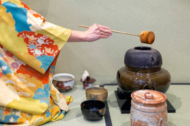 istock Woman in yellow kimono is going to start tea ceremony. 2189764718