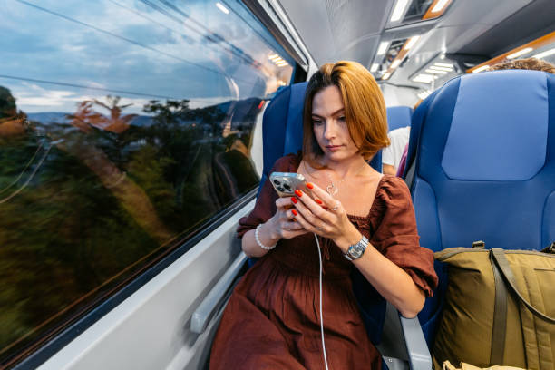 istock Mid-Adult Woman Using Phone While Riding On The Train In Italy 2189765254