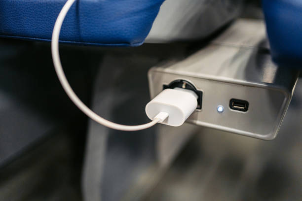 Phone charger plugged in next to a train seat in Italy.