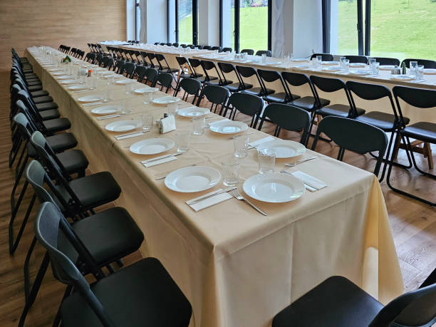 istock Served long table in a large dining room. Cutlery on the table. Wedding table without guests. Hall for ceremonial banquets on the occasion of important events for a large group of people 2189767672