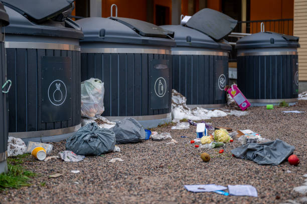 istock Overflowing garbage containers with scattered waste, including food and trash bags, concept of pollution 2189771437