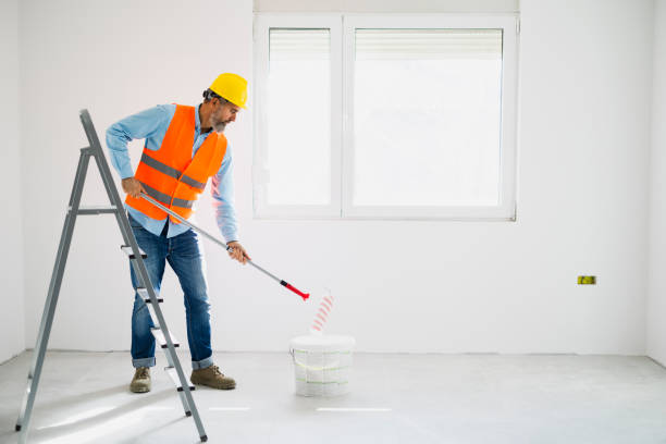 istock Man painting wall at home 2189773058