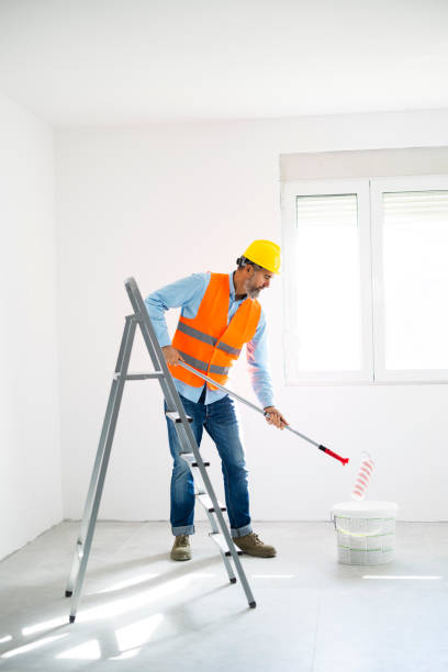 istock Man painting wall at home 2189773110