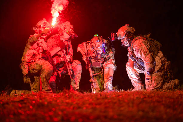 War concept. Silhouette of a soldier at night with full military equipment in a dangerous military area.Selective focus. High-quality photo