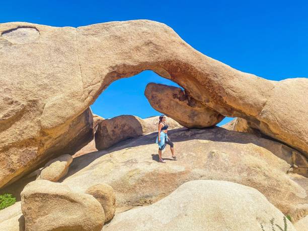 istock Woman standing on a rock formation 2189781773