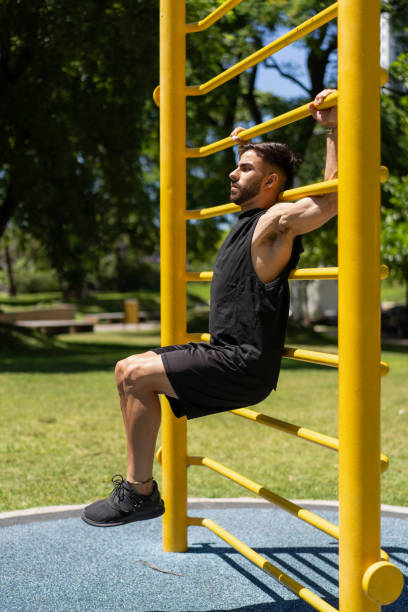 istock Fit young man performing abdominal exercises on outdoor bars 2189782255