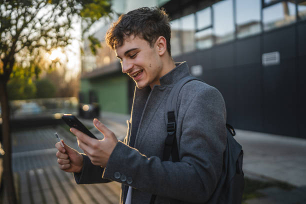 istock man shop online on cellphone with credit card in front modern building 2189782833