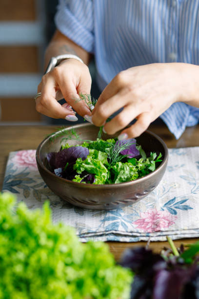 istock A nutritionist woman preparing a mixed salad, close up 2189783233