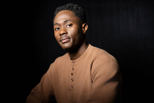 istock Thoughtful Expression of a Young Black Man in Soft Light 2189785636