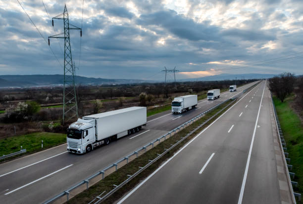 istock Caravan or convoy of white trucks 2189785819