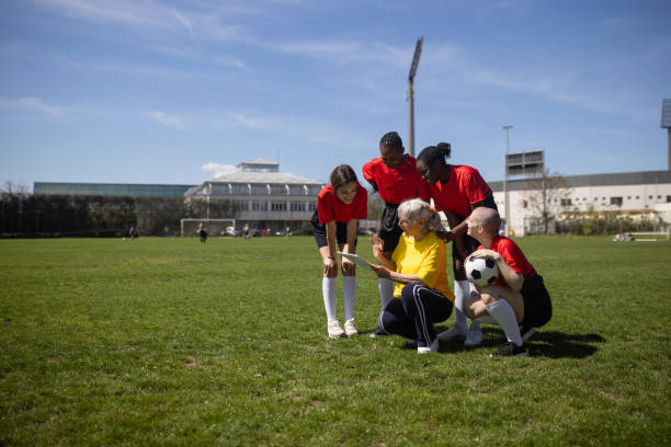 istock Female Coach Discussing Strategy with Soccer Players 2189785853