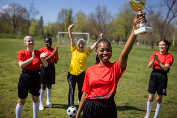 istock Soccer team and coach celebrating a trophy 2189787363