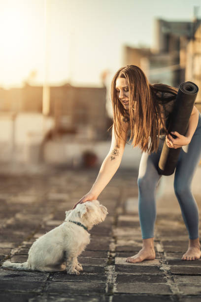 istock Woman Rolling Up Yoga Mat And Preparing To Outdoors Training 2189788056