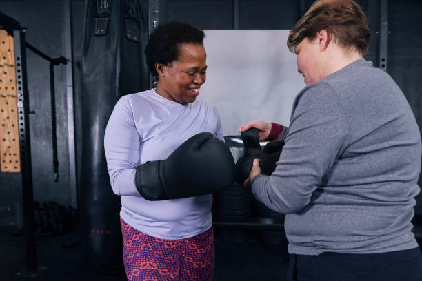 istock People tying boxing gloves in gym 2189789920