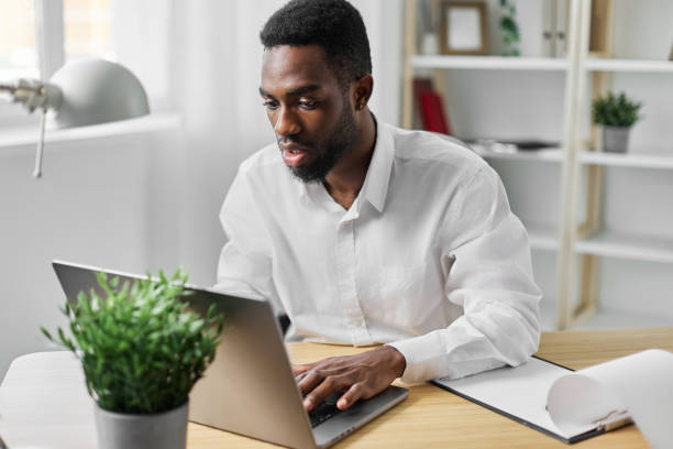 istock laptop man freelancer office american education online job computer student home african 2189794549