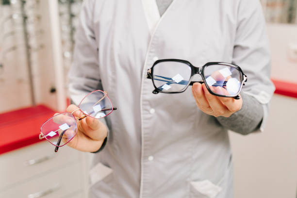 istock Ophthalmologist offers eyeglasses with different frames after checkup in the optical clinic. Correcting eye diseases using glasses with clear lenses. 2189794583