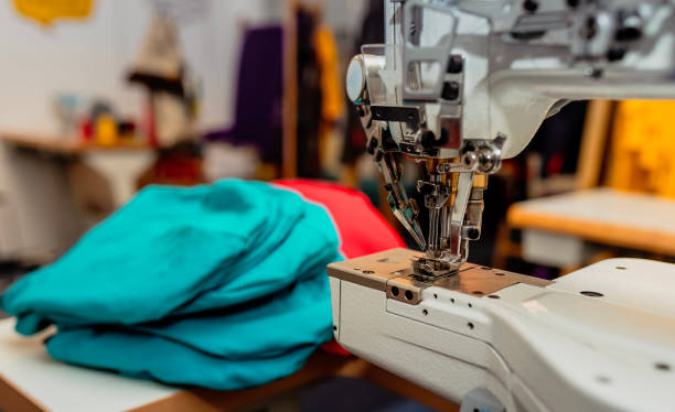 istock Industrial Sewing Machine with Fabric in a Professional Tailoring Workshop 2189794651