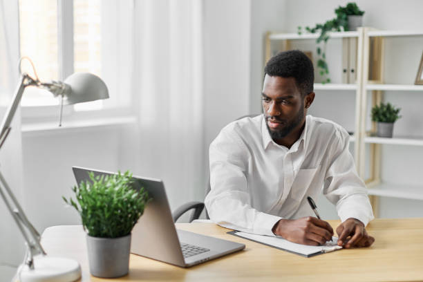 istock man education american office student freelancer internet online computer job laptop african 2189794744